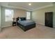 Spacious bedroom with neutral carpet, tray ceiling, and ample natural light from two windows at 11134 Horned Owl Rd, Weeki Wachee, FL 34614