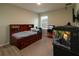 This carpeted bedroom features a wood-framed bed, an aquarium, and a window with blinds at 11134 Horned Owl Rd, Weeki Wachee, FL 34614