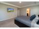 Relaxing bedroom featuring a TV, carpet floors, a comfortable bed, and ensuite bathroom at 11134 Horned Owl Rd, Weeki Wachee, FL 34614