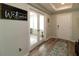 Inviting entryway with wood-look flooring and decorative 'Welcome' sign, offering a warm greeting at 11134 Horned Owl Rd, Weeki Wachee, FL 34614