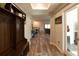 Inviting entryway with hardwood floors, coat rack and views into the living areas at 11134 Horned Owl Rd, Weeki Wachee, FL 34614