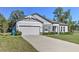 Charming single-story home with a well-manicured lawn and gray exterior at 11134 Horned Owl Rd, Weeki Wachee, FL 34614