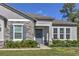A close up of the front entrance features gray stonework and meticulously maintained landscaping at 11134 Horned Owl Rd, Weeki Wachee, FL 34614
