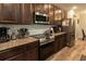 Modern kitchen with stainless steel appliances, granite countertops, and dark wood cabinetry at 11134 Horned Owl Rd, Weeki Wachee, FL 34614