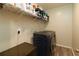 A laundry room features a washing machine, wire shelf, and ample storage space at 11134 Horned Owl Rd, Weeki Wachee, FL 34614