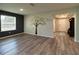 Inviting living room with stylish paint, hardwood floors, and a decorative tree wall decal at 11134 Horned Owl Rd, Weeki Wachee, FL 34614