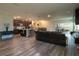 Spacious living room open to kitchen, featuring wood floors and sliding glass doors to the backyard at 11134 Horned Owl Rd, Weeki Wachee, FL 34614