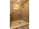 Modern walk-in shower featuring elegant tilework and a glass door, blending style with functionality at 11134 Horned Owl Rd, Weeki Wachee, FL 34614