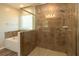 Luxurious bathroom featuring a glass-enclosed shower and separate soaking tub for ultimate relaxation at 11134 Horned Owl Rd, Weeki Wachee, FL 34614