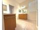 This neutral-toned bathroom features a wood vanity and tiled flooring at 11204 Clear Oak Cir, New Port Richey, FL 34654