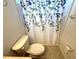 Cozy bathroom featuring a toilet with a shower curtain with leaf pattern at 11204 Clear Oak Cir, New Port Richey, FL 34654