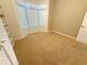 Cozy bedroom with neutral carpet, bay window and charming wicker shelving unit at 11204 Clear Oak Cir, New Port Richey, FL 34654
