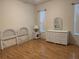 Bright bedroom with wood floors features white wicker furniture and natural light at 11204 Clear Oak Cir, New Port Richey, FL 34654