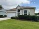 Lovely single-story home with a well-kept lawn, two-car garage, and decorative front door at 11204 Clear Oak Cir, New Port Richey, FL 34654