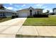 Inviting single-story home with a well-manicured lawn and a spacious driveway at 11204 Clear Oak Cir, New Port Richey, FL 34654
