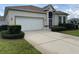 Charming single-story home featuring a well-maintained lawn and a two-car garage at 11204 Clear Oak Cir, New Port Richey, FL 34654