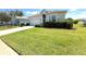 Well-maintained home exterior with lush green lawn and mature landscaping adding to its curb appeal at 11204 Clear Oak Cir, New Port Richey, FL 34654