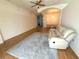 Cozy living room boasting stylish hardwood floors, a comfortable reclining couch, and ample natural light at 11204 Clear Oak Cir, New Port Richey, FL 34654