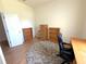 Bright office featuring a work desk, bookshelves, and a round patterned rug on laminate flooring at 11204 Clear Oak Cir, New Port Richey, FL 34654