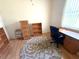 Bright office featuring a work desk, bookshelves, and a round patterned rug on laminate flooring at 11204 Clear Oak Cir, New Port Richey, FL 34654