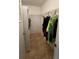 Walk-in closet with clothes hanging on a rod, and wire shelving for ample storage space at 13026 Lawrence St, Spring Hill, FL 34609