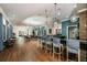 Long bar area with modern lighting, barstools, hardwood floors, and stylish decor at 17026 Shell Bay Dr, Land O Lakes, FL 34638