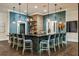 Stylish bar area with modern light fixtures, barstools, and decorative shelving and decor at 17026 Shell Bay Dr, Land O Lakes, FL 34638