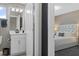 Well-lit bathroom featuring a modern vanity and view into the bedroom at 17026 Shell Bay Dr, Land O Lakes, FL 34638