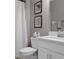 This bathroom features a toilet, shower and vanity with framed art hung on the wall at 17026 Shell Bay Dr, Land O Lakes, FL 34638