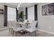 Bright dining room features elegant lighting, modern table with seating for six, and stylish decor at 17026 Shell Bay Dr, Land O Lakes, FL 34638