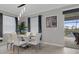 Bright dining room features elegant lighting, modern table with seating for six, and sliding glass doors to the outdoor area at 17026 Shell Bay Dr, Land O Lakes, FL 34638