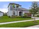 Attractive two-story home with verdant lawn, complemented by palm trees and tasteful landscaping at 17026 Shell Bay Dr, Land O Lakes, FL 34638