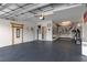 Spacious garage featuring black flooring, white walls, bike rack, storage, and an American flag at 17026 Shell Bay Dr, Land O Lakes, FL 34638