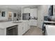 Spacious kitchen features white cabinetry, stainless steel appliances, and an open layout connecting to the living area at 17026 Shell Bay Dr, Land O Lakes, FL 34638