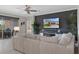Comfortable living area with a large sofa, entertainment center, and access to an outdoor patio at 17026 Shell Bay Dr, Land O Lakes, FL 34638