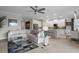 Bright, open-concept living space with modern furnishings, a large sectional sofa, and seamless access to the kitchen at 17026 Shell Bay Dr, Land O Lakes, FL 34638