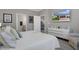 This main bedroom has a large window, media center and en suite bathroom at 17026 Shell Bay Dr, Land O Lakes, FL 34638