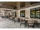Outdoor seating area with brick flooring, ceiling fans, and modern patio furniture overlooking the pool at 17026 Shell Bay Dr, Land O Lakes, FL 34638