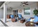 Covered patio with comfortable seating and ceiling fans at 17026 Shell Bay Dr, Land O Lakes, FL 34638
