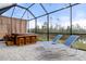Covered patio with hot tub, bar and lounge chairs at 17026 Shell Bay Dr, Land O Lakes, FL 34638