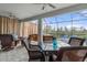 Outdoor patio with dining and seating areas overlooking the backyard at 17026 Shell Bay Dr, Land O Lakes, FL 34638
