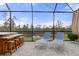 Relaxing screened-in patio with lounge chairs and a hot tub at 17026 Shell Bay Dr, Land O Lakes, FL 34638