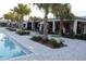 Beautiful poolside view with palm trees and outdoor dining at 17026 Shell Bay Dr, Land O Lakes, FL 34638