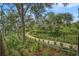 Scenic walking path winds through lush landscaping and mature trees, providing a tranquil outdoor experience at 17026 Shell Bay Dr, Land O Lakes, FL 34638