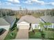 Beautiful aerial view of single-Gathering home with brick driveway, well-manicured lawn and tropical landscaping at 18629 Coastal Shore Ter, Land O Lakes, FL 34638