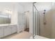 Bathroom showcasing tiled floors, double vanity, large mirror, and modern glass shower at 18629 Coastal Shore Ter, Land O Lakes, FL 34638