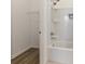 Bright bathroom features shower-tub combo and shelving, creating a functional and well-organized space at 18629 Coastal Shore Ter, Land O Lakes, FL 34638
