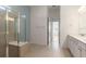 Bathroom featuring tiled floors, glass-enclosed shower, and a white vanity with countertop space at 18629 Coastal Shore Ter, Land O Lakes, FL 34638