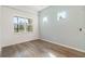 Comfortable bedroom with hardwood floors and a large window with natural light at 18629 Coastal Shore Ter, Land O Lakes, FL 34638