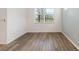 Bright bedroom featuring hardwood floors and a large window at 18629 Coastal Shore Ter, Land O Lakes, FL 34638